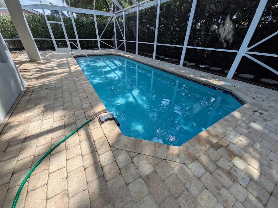 Screened-in pool with paver deck in South Florida